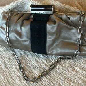 Beautiful silver and black clutch with shoulder or mid arm strap.